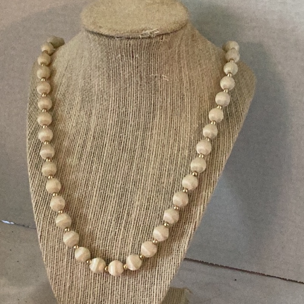 Nice beaded necklace . Crème coloured with gold spacers .